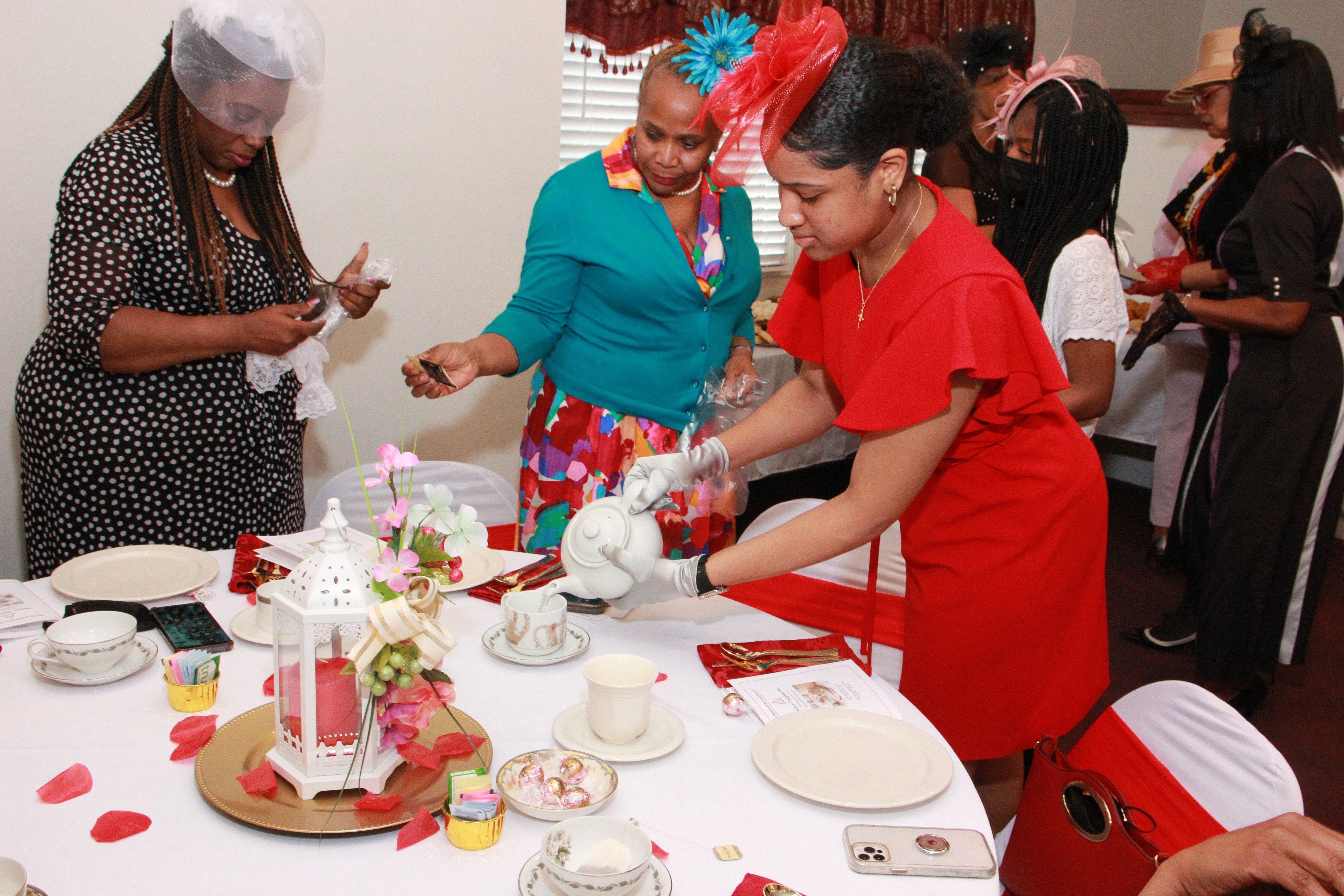 Young lady pouring tea into teacup